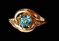 This is the Blue Flame in 14K Yellow Gold with a fine Bright Blue Sapphire, call for custom pricing dependent on Size, Color and Quality of each Sapphire